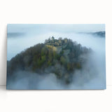 Stretched canvas artwork depicting a scenic landscape with a majestic castle nestled among lush green hills, showcasing vibrant colors and intricate details.