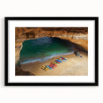 Black-framed landscape artwork featuring dramatic cliffs and vibrant colors, elegantly matted for a polished presentation, perfect for home decor.