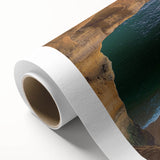 Vibrant rolled canvas artwork showcasing a breathtaking landscape of rugged cliffs and serene ocean waves, perfect for enhancing home decor with natural beauty.