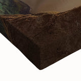 Close-up of a stretched canvas artwork showcasing a vibrant landscape of rugged cliffs, displaying rich colors and intricate textures, perfect for home decor.