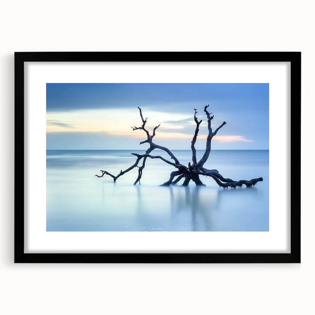 Black-framed landscape artwork featuring serene beach scenery with gentle waves and a vibrant sunset, suitable for home decor and coastal-themed interiors.
