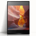 Framed acrylic artwork showcasing a vibrant desert landscape with warm hues of orange and yellow, set against a sleek black frame, perfect for modern home decor.