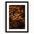 Extra large, abstract art print of colorful, textured fall foliage in a black frame, ideal for living room ambiance.