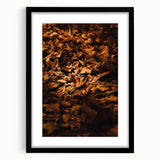 Extra large, abstract art print of colorful, textured fall foliage in a black frame, ideal for living room ambiance.
