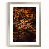 Textured abstract art print of autumnal colors on a silver-framed canvas, suitable for bedroom decor.