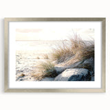 Textured abstract art print in muted earth tones, framed in silver, ideal for bedroom wall decor.