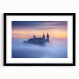 Elegant black-framed landscape artwork showcasing a majestic castle surrounded by lush greenery, featuring a white mat for added contrast, perfect for home decor.