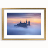 Elegant gold-framed landscape print featuring a majestic castle set against a serene backdrop of rolling hills and vibrant skies, perfect for home decor.