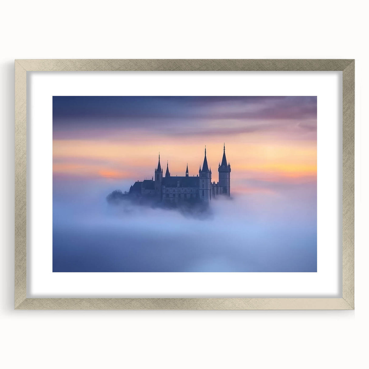 Silver-framed landscape artwork featuring a picturesque castle scene, elegantly matted with a soft white border, ideal for home decor or gallery display.