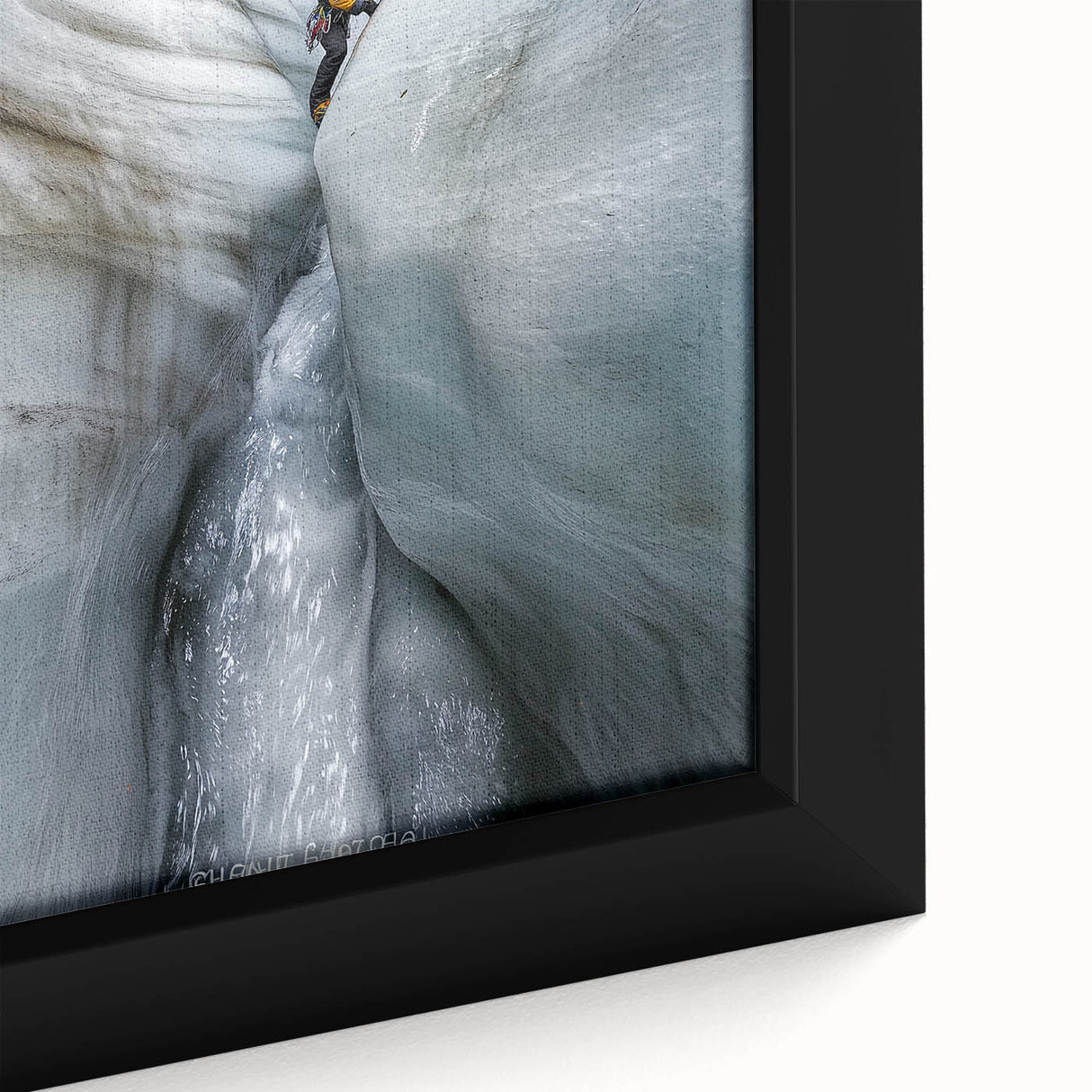 Close-up of a framed canvas artwork depicting a serene landscape with intricate cave formations, showcasing earthy tones of brown and green, perfect for home decor.
