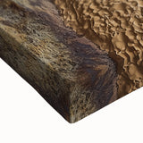 Close-up of a stretched canvas artwork depicting dramatic cliffs and landscapes, showcasing vibrant colors and intricate details, perfect for home decor.