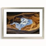 Framed landscape artwork depicting majestic canyons in vibrant colors, enclosed in a stylish silver frame with a white mat, perfect for home decor.