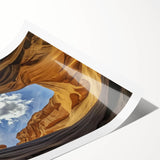 Landscape art print showcasing vibrant canyons in warm earth tones, rolled and ready for display. Ideal for nature lovers seeking to enhance their home decor.