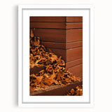 Abstract art print featuring autumnal colors in a white frame, ideal for dining room decor.