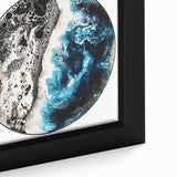 Close-up of a framed abstract geometric canvas featuring a vibrant color palette of blues, greens, and yellows, highlighting intricate shapes and patterns, perfect for modern decor.