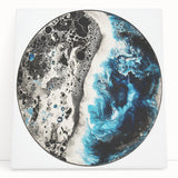 Abstract geometric stretched canvas artwork featuring vibrant blue and gold tones, elegantly leaning against a textured wall, ideal for modern home decor.