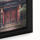 Close-up of a framed canvas featuring a textured black door with colorful, abstract Japanese motifs.