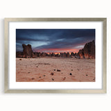 Abstract art print depicting an Algerian landscape in muted earth tones, framed with a silver mat.
