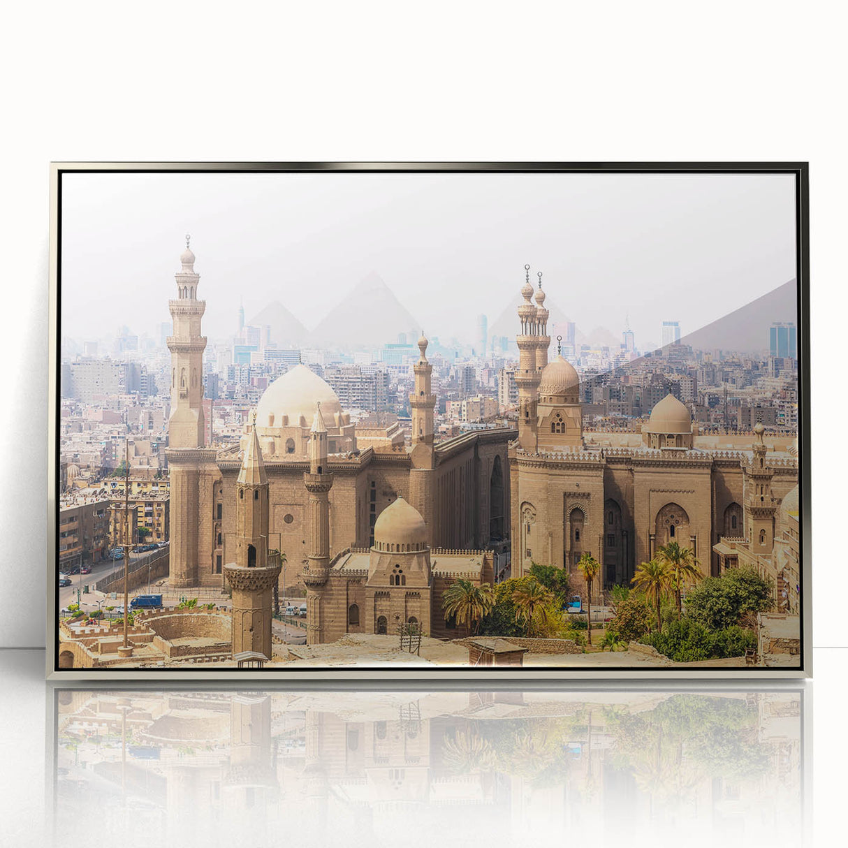 Art deco poster of an Egyptian landscape in muted gold and blue tones, framed in silver acrylic.