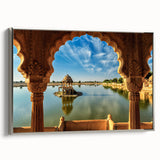 Landscape art painting of a scenic Indian setting on a framed canvas, featuring vibrant colors against a black background.