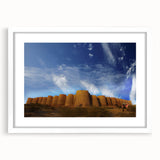 Abstract art print of a Pakistani landscape in muted earth tones on a framed white mat, ideal for dining room decor.