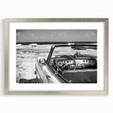 Abstract art print of a Caribbean scene in muted blue and green tones, framed in silver, ideal for dining room decor.