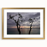 Abstract art print of a Caribbean scenery in muted blue and green tones, framed in gold, ideal for dining room decor.
