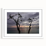 Textured art depicting an abstract Caribbean scenery in muted blue and green tones on a framed white mat.