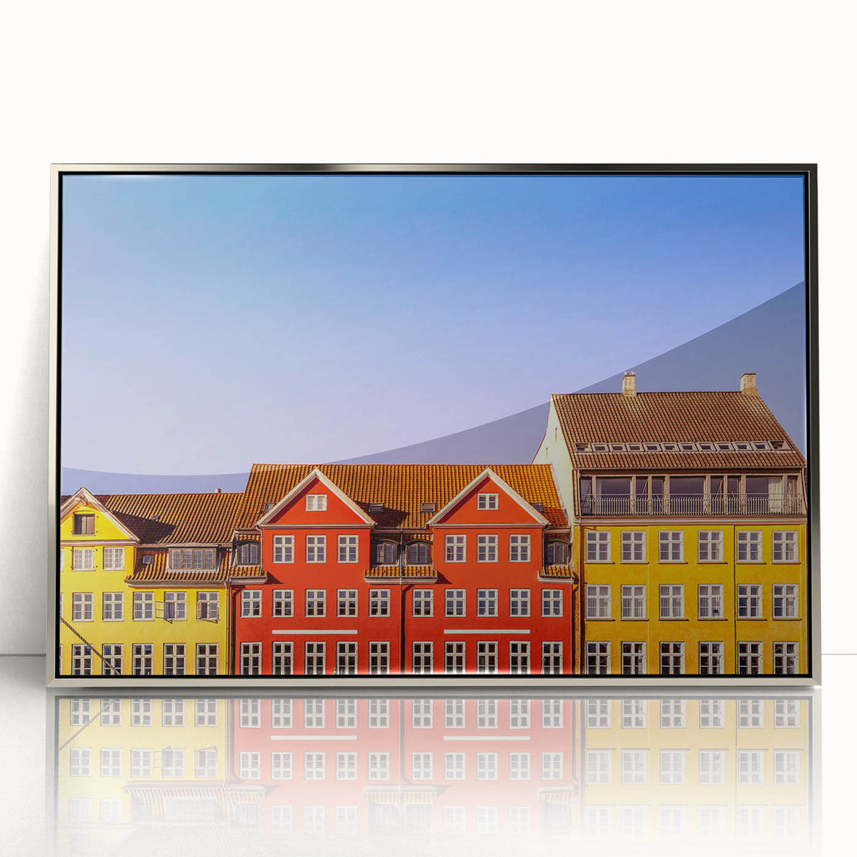 Large art print of a European cityscape in muted gray and blue tones on a silver-framed acrylic.