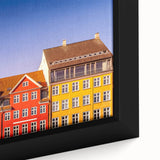 Extra large framed canvas featuring a textured depiction of a European scenery in black with colorful accents.