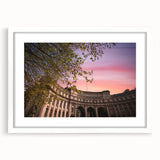 Textured abstract art print of a European scenery in muted earth tones on a framed white mat, suitable for bedroom decor.