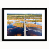 Colorful abstract art print of a European scenery in vibrant hues on a large textured canvas, framed in black.