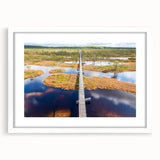 Textured art print depicting an abstract European scenery in muted earth tones, framed with a white mat.