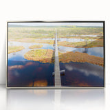 Large art print of a European Estonian landscape in muted green and blue tones, framed in silver acrylic.