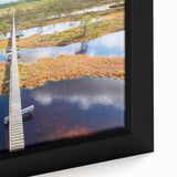 Extra large framed canvas featuring a textured depiction of a European scenery in black with colorful accents.