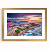 Abstract art print of a European coastal scene with muted blue and tan hues, framed in gold, ideal for dining room decor.