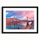 Colorful abstract art print of Lyon scenery in vibrant hues, framed with a black mat, ideal for living room decor.