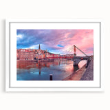 Textured art depicting an abstract Lyon cityscape in muted earth tones on a framed white mat, ideal for bedroom wall decor.