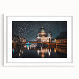 Textured abstract art print depicting Berlin scenery in muted gray and blue tones, framed with a white mat.