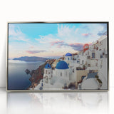 Acrylic print of Santorini landscape with white buildings and blue rooftops, framed in silver.