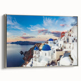 Framed canvas featuring a vintage-style landscape painting of Santorini with colorful buildings and silver frame.