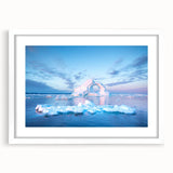 Textured abstract art print of a Greenland scenery in muted green and blue tones, framed with a white mat.