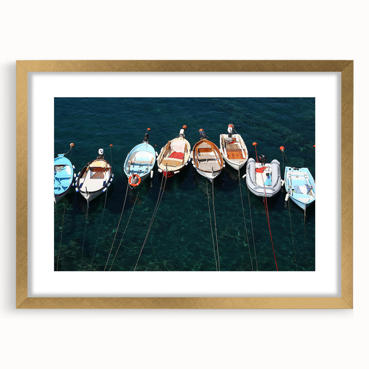 Abstract art print of Cinque Terre with vibrant coastal hues on a framed gold mat, ideal for dining room decor.