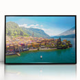 Large abstract wall art of Lake Como with muted blue and green tones, framed in black acrylic.