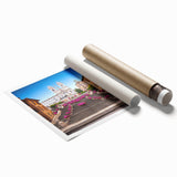 Rolled print of Rome scenery with floral elements in soft earth tones, ideal for classy bathroom wall art.