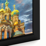 Black wall art featuring a textured depiction of a European cityscape in vibrant colors on a framed canvas.