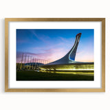 Abstract art print of Sochi scenery in muted gold and blue tones, framed with a gold mat, suitable for dining room decor.
