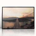 Large abstract wall art depicting a European scenery in muted earth tones, framed in black acrylic.