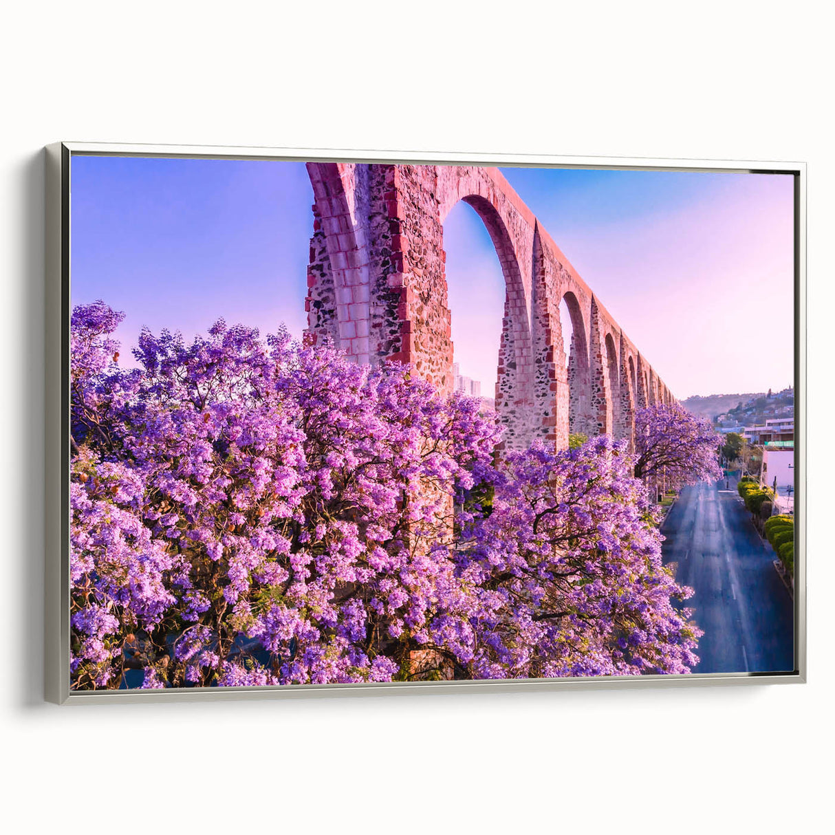 Framed canvas of a vintage-style landscape painting depicting Guanajuato, Mexico, with vibrant colors on a black background.