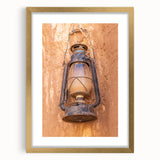 Abstract art print of a Middle Eastern desert scene in gold and beige tones on a large framed canvas.